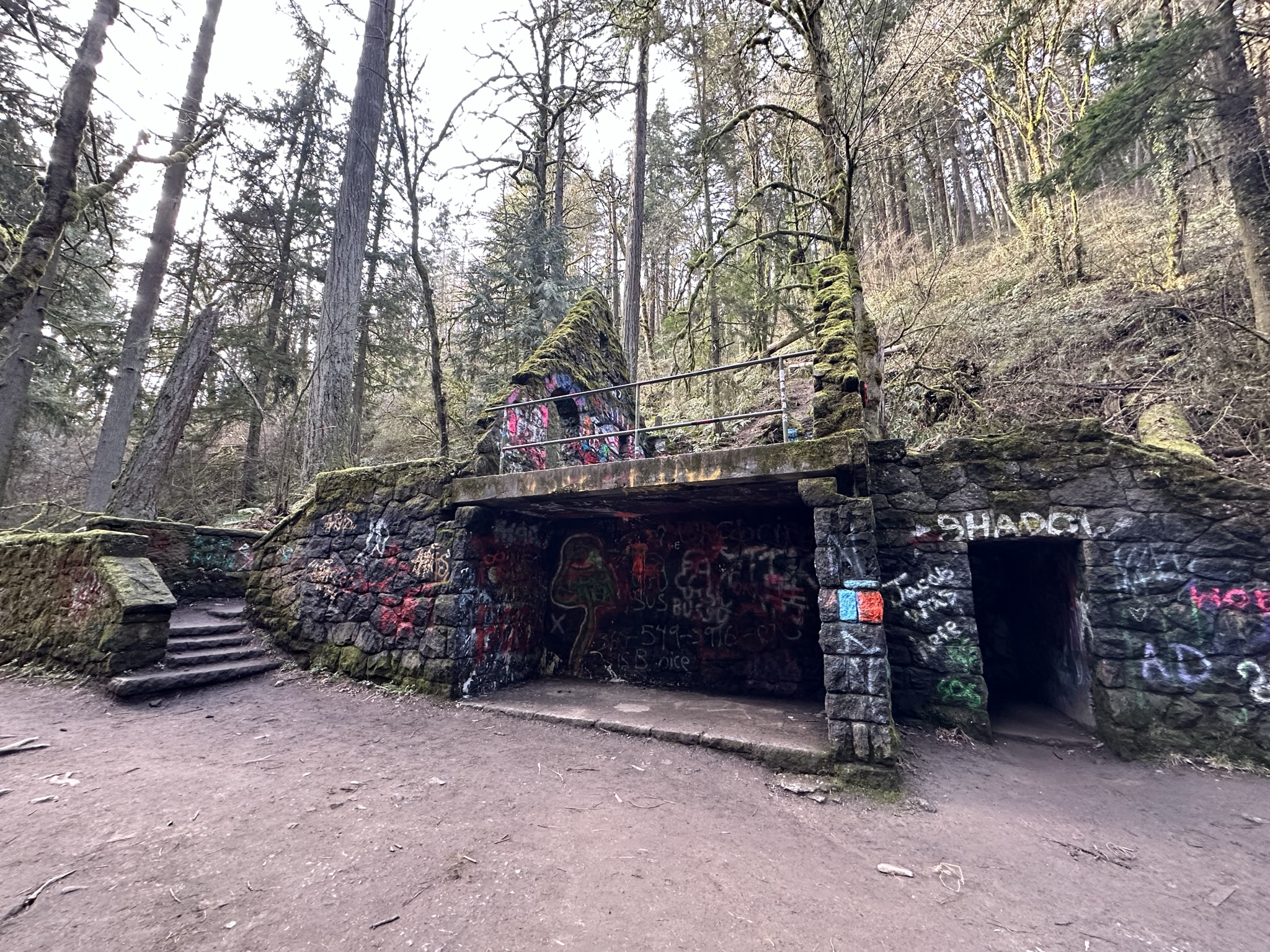 Moss-covered stone ruins known as the Witch’s Castle beside a Forest Park trail
