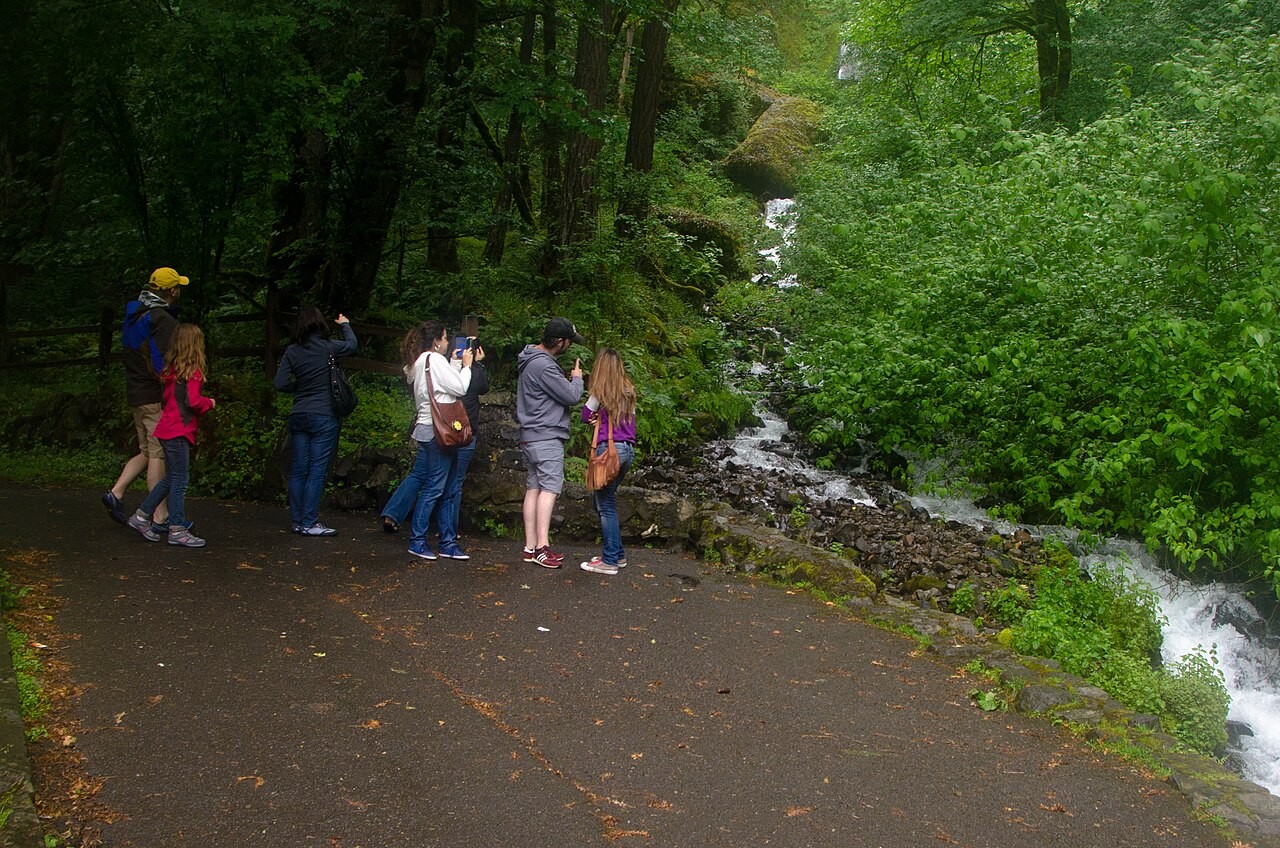 A family at the old Wahkeena Falls viewing area during rain