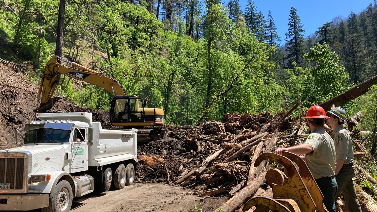 Forest Service staff monitoring contractors clearing landslide debris near Eagle Creek